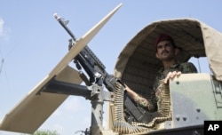 Afghanistan's National Army soldier stands guard in his vehicle in Camp Khogyani in Nangarhar province, east of Kabul, Afghanistan.