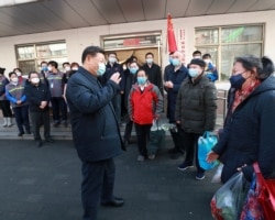 Chinese President Xi Jinping inspects the novel coronavirus prevention and control work at Anhuali Community in Beijing, Feb. 10, 2020.