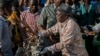 FILE - Tanzanian President John Magufuli joins a cleanup event outside the State House in Dar es Salaam, Dec. 9, 2015.