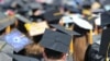 FILE - In this May 5, 2018, file photo, graduates at the University of Toledo commencement ceremony in Toledo, Ohio. Colleges across the U.S. have begun cancelling and curtailing spring graduation events amid fears from the coronavirus. 