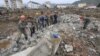 FILE - Workers recover cement blocks from flood-damaged areas in Onsong, North Hamgyong Province, North Korea, Sept. 16, 2016. Amid recent nuclear tensions, Pyongyang is struggling to secure aid for victims of flooding that occurred earlier this month.