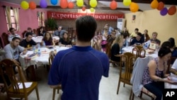 FILE - Foreigners looking for work as English teachers in China take part in a training session in Beijing, China, Aug. 25, 2009.