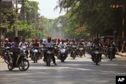 Hard-line Buddhists ride on motorbikes during a protest march, led by Rakhine State's dominant Arakan National Party, against the government's plan to give citizenship to some members of the persecuted Rohingya Muslim minority community in Sittwe, Rakhine state, Myanmar, March 19, 2017.