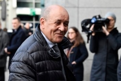 FILE - French Foreign Minister Jean-Yves Le Drian speaks with journalists at the EEAS building in Brussels, Jan. 7, 2020.