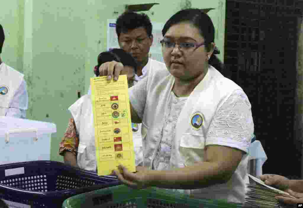 Myanmar election commission officer shows a ballot to count votes at a polling station during the country’s general election in Yangon, Nov. 8, 2015.