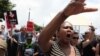 Demonstrators take part in a protest march across the Nelson Mandela bridge into Johannesburg, South Africa, Dec. 16, 2015. 