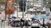 Somali security forces secure the road leading to the scene of an explosion at a checkpoint near the Presidential palace in Mogadishu, Somalia February 10, 2022.