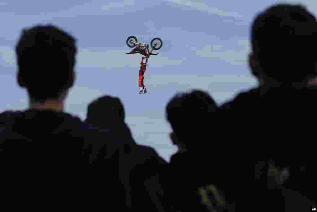 Riders perform during a freestyle motocross show at the EICMA exhibition motorcycle fair in Rho, outskirt of Milan, Italy, Nov. 7, 2024.