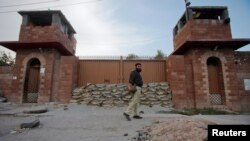 FILE - A police officer walks past Central Jail in Peshawar, June 21, 2012. 