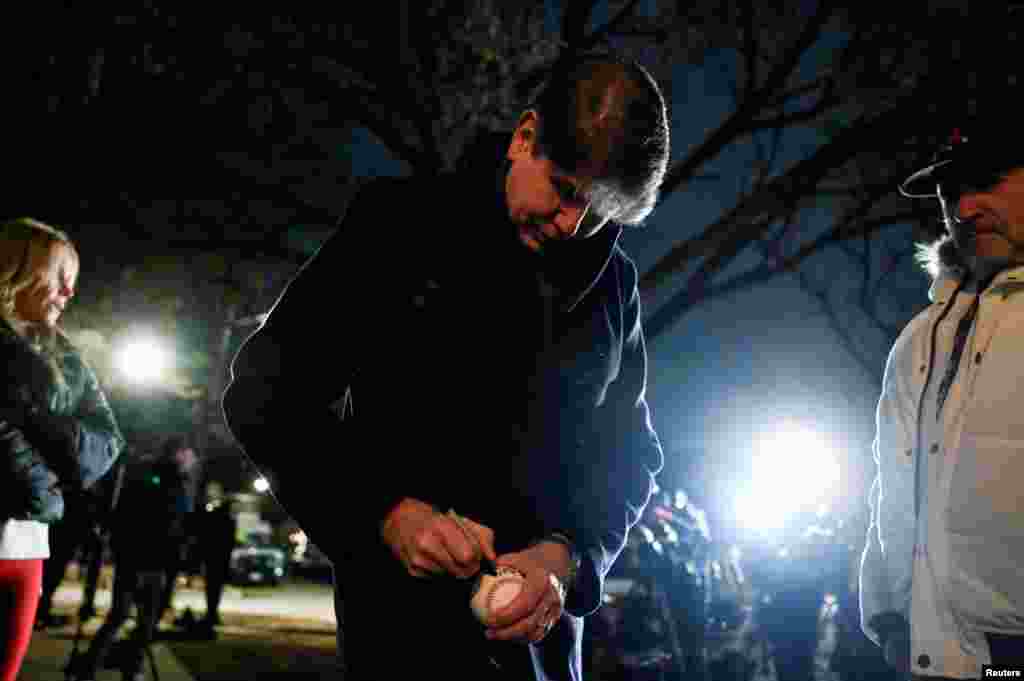 Former Illinois Governor Rod Blagojevich, a Democrat and former contestant on "The Celebrity Apprentice", who was convicted of corruption for trying to sell former President Barack Obama's vacated Senate seat, signs a ball for a supporter outside his house, after he was pardoned by President Donald Trump, in Chicago, Feb. 10, 2025.