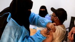 FILE - A man receives the AstraZeneca vaccine against COVID-19 at a medical center in Taiz, Yemen, April 23, 2021.