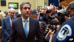Michael Cohen, President Donald Trump's former lawyer, departs after testifying before the House Oversight and Reform Committee, on Capitol Hill, Feb. 27, 2019, in Washington.