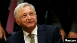 FILE - Mexico's President Andres Manuel Lopez Obrador looks on during a meeting with industry bosses and members of his cabinet to discuss the new administration's policy on the minimum wage at National Palace in Mexico City, Dec. 17, 2018.