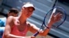 FILE - Russian tennis player Maria Sharapova touches her racket at the end of her match against Colombian Mariana Duque Marino in Madrid, May 5, 2015. 