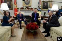 President Donald Trump and Vice President Mike Pence meet with Senate Minority Leader Chuck Schumer, D-N.Y., and House Minority Leader Nancy Pelosi, D-Calif., in the Oval Office of the White House, Dec. 11, 2018, in Washington.