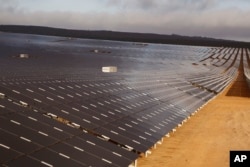 FILE - A photovoltaic solar park situated on the outskirts of the coastal town of Lamberts Bay, South Africa on March. 29, 2016.