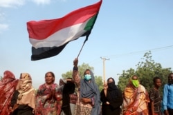 Sudanese protest against a military coup that overthrew the transition to civilian rule, in the al-Shajara district in southern Khartoum, on October 25, 2021.