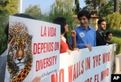 File photo shows environmental and immigration protesters in Pasadena, Calif., Aug. 7, 2018.