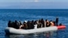FILE - A Greek coast guard boat intercepts a dinghy with migrants near the Greek island of Lesbos, after it crossed the Aegean Sea from Turkey, March 1, 2020.