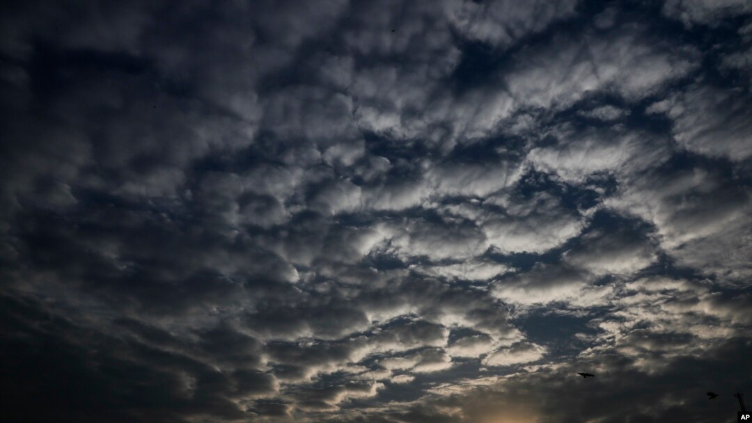 Sun sets behind a patterned cloud formed over the city in Kolkata, West Bengal state, India, Monday, May 18, 2020. A cyclonic storm 'Amphan' has intensified into a super cyclone.