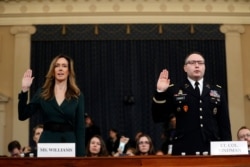 Jennifer Williams, an aide to Vice President Mike Pence, left, and National Security Council aide Lt. Col. Alexander Vindman, are sworn in to testify before the House Intelligence Committee on Capitol Hill in Washington, Nov. 19, 2019.