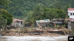 Debris gathers along a bridge after floods caused by Tropical Trami — locally named Kristine —hit and damaged parts of Polangui, Albay province, Philippines, Oct. 23, 2024.