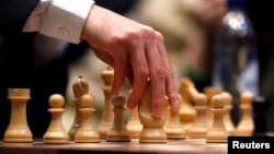FILE - Magnus Carlsen v. Fabiano Caruana at the 2018 World Chess Championship, London, Nov. 26, 2018. 