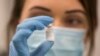 Seorang petugas medis menunjukkan ampul vaksin Covid-19 buatan Pfizer-BioNTech seiring dengan dimulainya program vaksinasi massal di Southmead Hospital di Bristol, Inggris, Selasa, 8 Desember 2020.