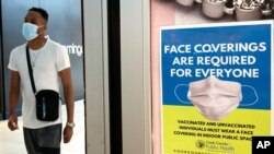 An information sign is displayed at a department store in Rosemont, Ill., Thursday, Aug. 26, 2021. Gov. J.B. Pritzker of Illinois announced on Thursday a new, stricter set of coronavirus restrictions, ordering a statewide indoor mask mandate and…