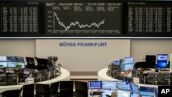 FILE - The curve of the German stock index DAX is seen at the stock market in Frankfurt, Germany, March 17, 2020, 