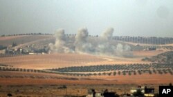 Smoke rises from the Syrian side of the border, in a photo taken from Karkamis, Turkey, Aug. 24, 2016. 