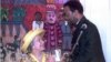 FILE - British Queen Elizabeth II looks up to Zulu King Zwelithini as he presents her a replica of a cup given to King Cetshwayo by Queen Victoria in 1882, here at a ceremonious luncheon in Durban, March 25, 1995.