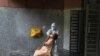 A health worker takes a nasal swab to test for COVID-19 in a government school in New Delhi, India, Thursday, Aug. 20, 2020. A simpler and quicker saliva test is being rolled out on U.S. campuses.