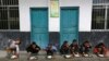 FILE - Students have lunch outdoors at a primary school in Tongguan village, Liping county, Guizhou province, November 24, 2014.