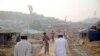 Rohingya refugees walk on a road at the Balukhali camp in Cox's Bazar on May 14, 2020.