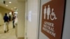 FILE- A sign marks the entrance to a gender-neutral restroom at the University of Vermont in Burlington, Vermont.