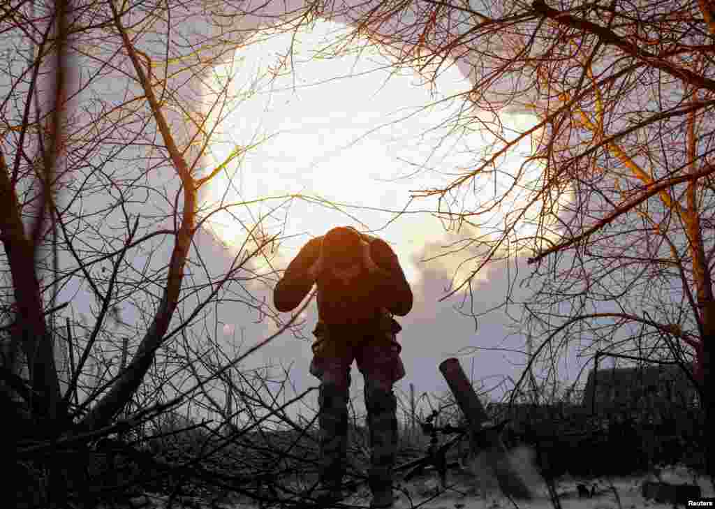 A serviceman of 57th Motorised Infantry Brigade of the Ukrainian Armed Forces reacts after firing a 120-mm mortar toward Russian troops, near the town of Vovchansk in the Kharkiv region, Ukraine, Jan. 16, 2025.