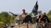 A Ukrainian military convoy moves along a road near Donetsk August 9, 2014.