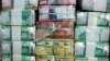  In this July 24, 2011, file photo, Sudan's new currency sits behind a window at the central bank in Khartoum, Sudan.