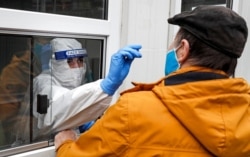 FILE - A medical staff member performs a COVID-19 test at a coronavirus test center in Cologne, Germany, Oct. 15, 2020. (AP)