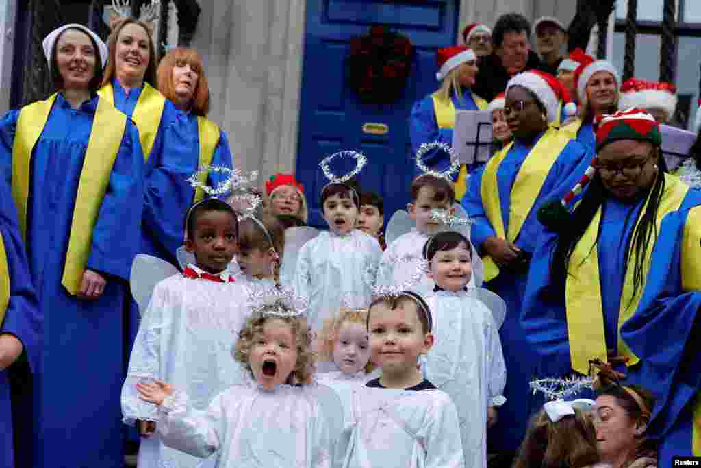 Children from St. Joseph's nursery sing alongside Lucan Gospel Choir at a live animal Christmas nativity crib, in Dublin, Ireland.