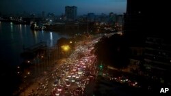 FILE - Traffic moves besides the Saigon river during rush hour in Ho Chi Minh City, Vietnam, Nov. 18, 2015. Senior officials warn air pollution levels in Ho Chi Minh City and Hanoi alone could soon match the deteriorating air quality of Beijing.