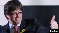 FILE - Carles Puigdemont, the dismissed president of Catalonia, arrives to speak after watching the results of Catalonia's regional election in Brussels, Belgium, Dec. 21, 2017.
