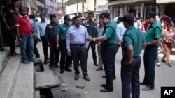 Bangladeshi police officers are seen investigating at the location where three motorcycle-riding assailants attacked secular student activist Nazimuddin Samad, in Dhaka, Bangladesh, April 7, 2016.
