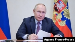 In this picture made available by Sputnik news agency, Russian President Vladimir Putin chairs a meeting with members of the government via a video conference at the Novo-Ogaryovo state residence outside Moscow, on Dec. 24, 2021. (Alexey Nikolsky/ Sputnik