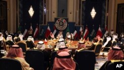 Kuwait's emir, Sheikh Sabah Al Ahmad Al Sabah, center, oversees the Gulf Cooperation Council summit in Kuwait City, Tuesday, Dec. 5, 2017. Kuwait hosted a meeting Tuesday of the Gulf Cooperation Council that saw Qatar's ruling emir attend, but other…
