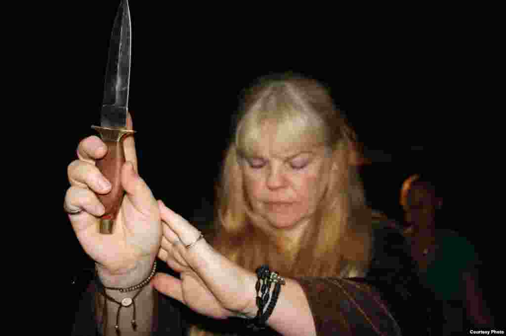 The high priestess holds up a ceremonial dagger to invoke aspects of the rites of ancient elders. "Most of us in this coven come from ancient Celtic roots,” she said.