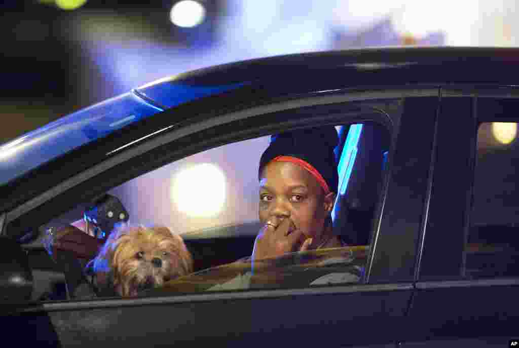 A passing motorist looks out her window as she stops at an intersection down the street from the Emanuel AME Church early Thursday, June 18, 2015 following a shooting Wednesday night in Charleston, S.C.