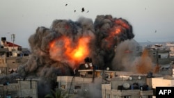 A ball of fire erupts from a building in Gaza City's Rimal residential district on May 16, 2021, during massive Israeli bombardment on the Hamas-controlled enclave.