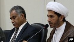 File - Opposition leaders Radhi Mohsen al-Mosawi (L) and Sheikh Ali Salman speak at a joint press conference in Umm Al Hassam, Bahrain.